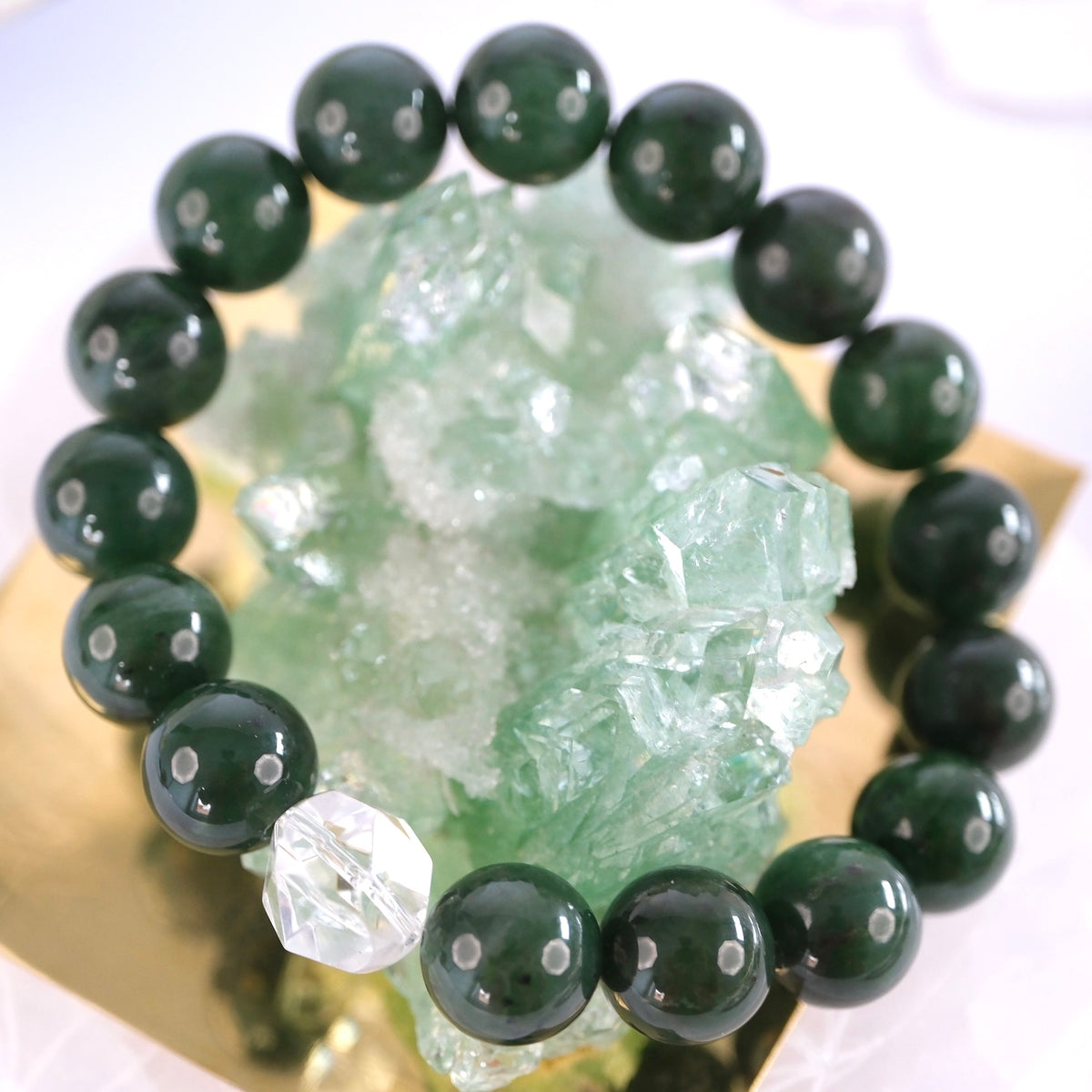 Jade Buddha bracelet of deep green 12mm jade with a single clear quartz, the Stone of Heaven, for luck and peace.
