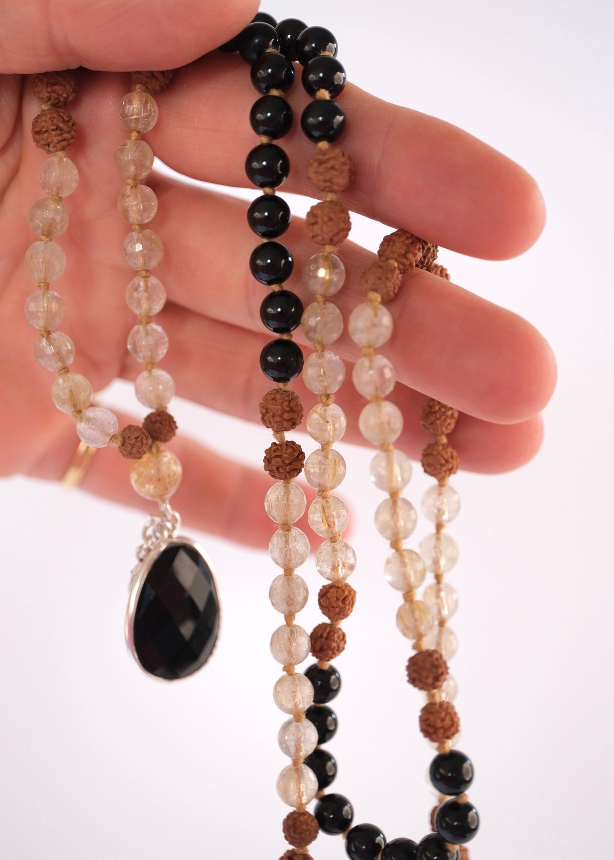 Double sided faceted black tourmaline pendant set in sterling silver
