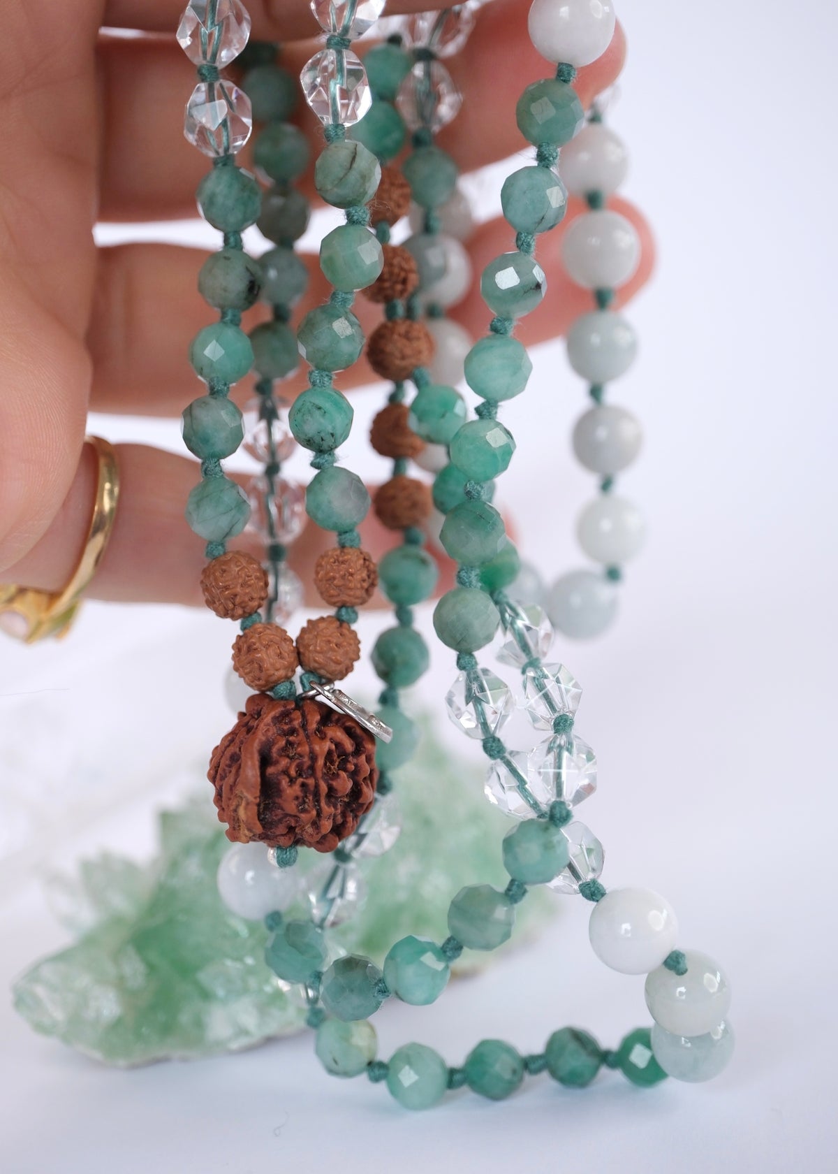 Close up of Emerald Mala with Ganesh Guru bead, herkimer and green jade