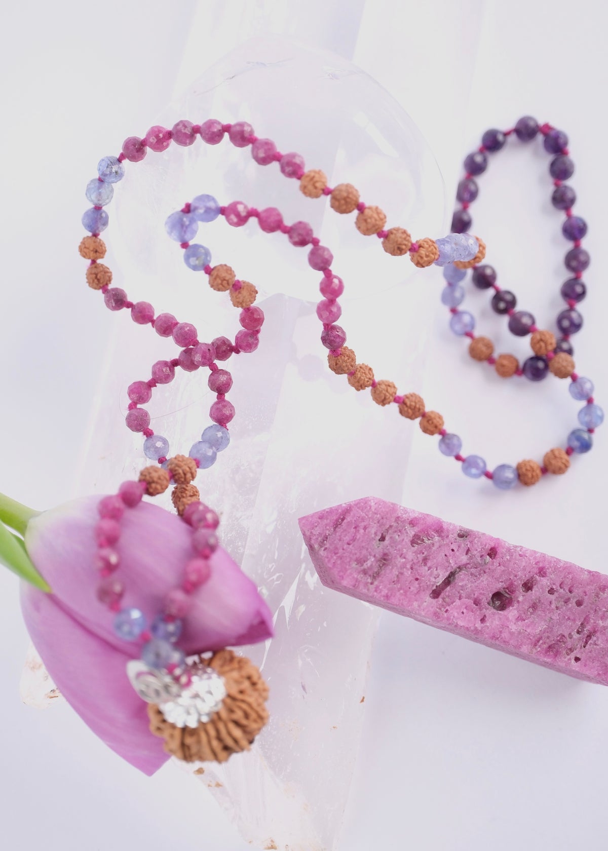 Durga warrior priestess mala with
Nepali nine mukhi Rudraksha guru bead with sterling silver caps,
Faceted ruby and tanzanite, and amethyst  beads on a handcrafted divine feminine mala