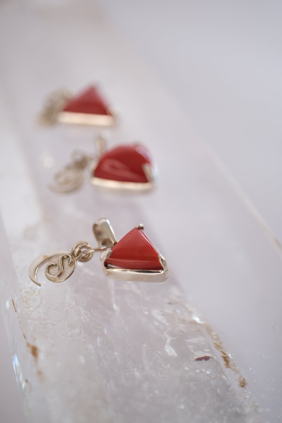 Genuine Corallium rubrum red coral set in a silver triangle, the yantra of the warrior planet Mars.