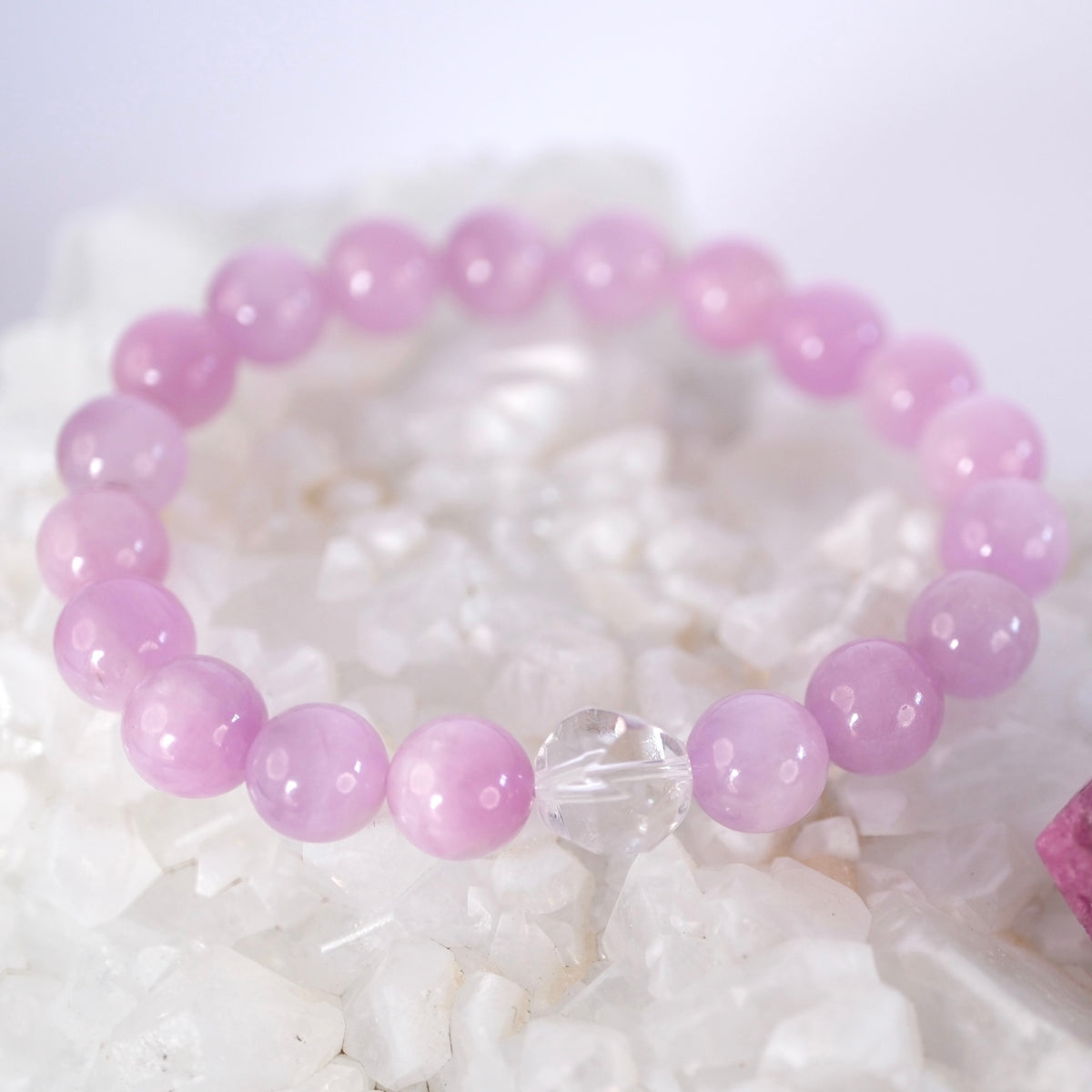 Rare kunzite and Herkimer diamond bracelet resting on quartz, love made luminous by Shivoham.
