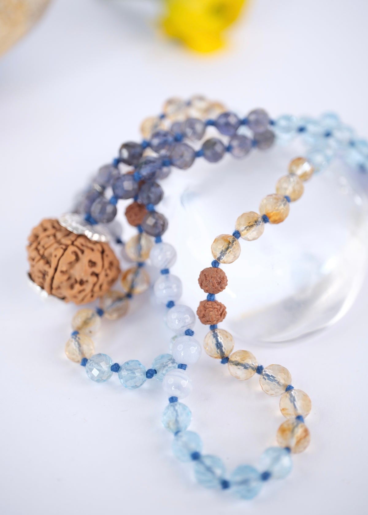 Faceted topaz and citrine beads on a handcrafted throat chakra mala with 10 mukhi rudraksha