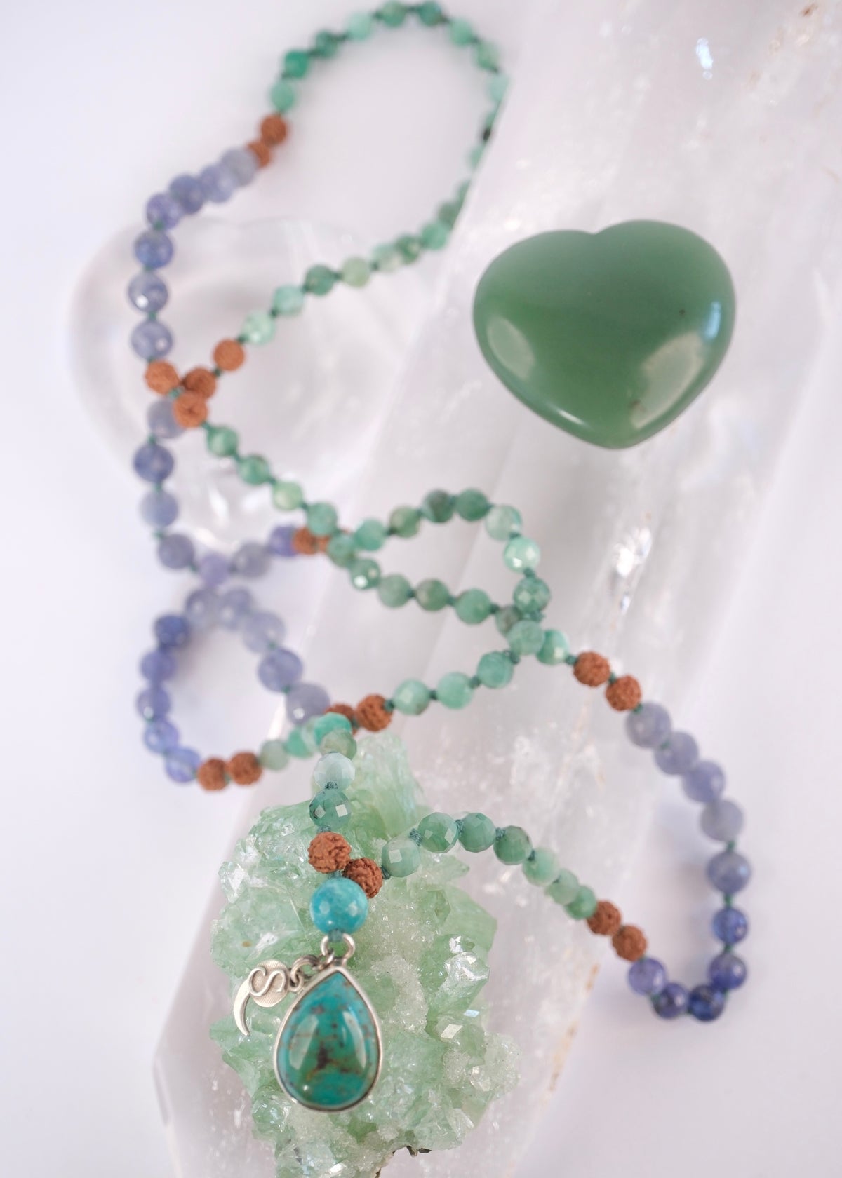 Shivoham premium Mala: Abhyudaya mala with faceted emerald, tanzanite, iolite, rudraksha and old mine Persian turquoise teardrop pendant