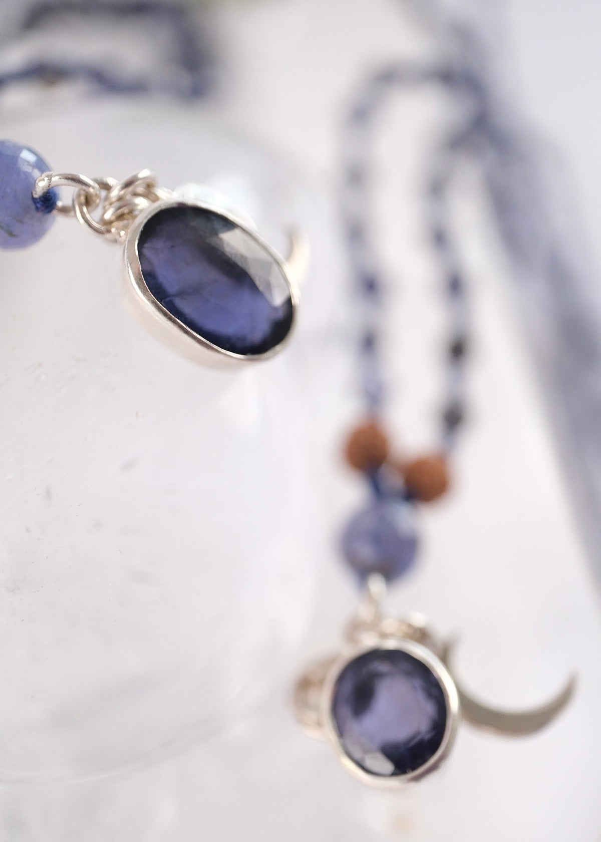 Close view of two faceted iolite pendants