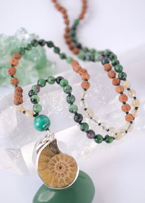 Handcrafted seer’s mala with ammonite pendant, ruby zoisite, golden rutilated quartz, malachite and Rudraksha. Blessed by the Ganga. Magic for sages and manifestation.