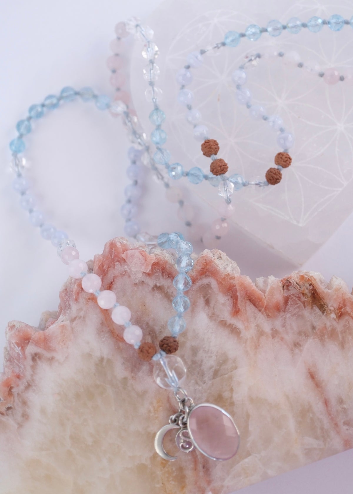 Rose quartz, faceted topaz and Herkimer style quartz beads with Rudraksha on the self love mala