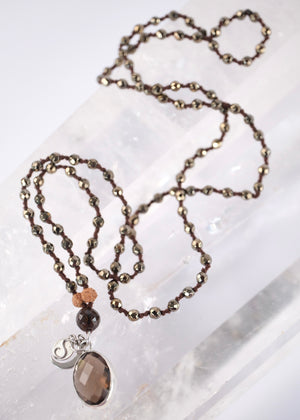 Handcrafted double knotted hematite mala with Rudraksha and a double sided faceted smoky quartz pendant, blessed by Ma Ganga.