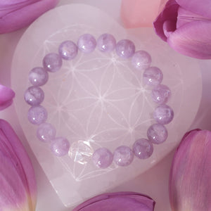 Gentle lilac quartz and Herkimer bracelet soft, serene, and uplifting. ON selenite heart and surrounded by flowers