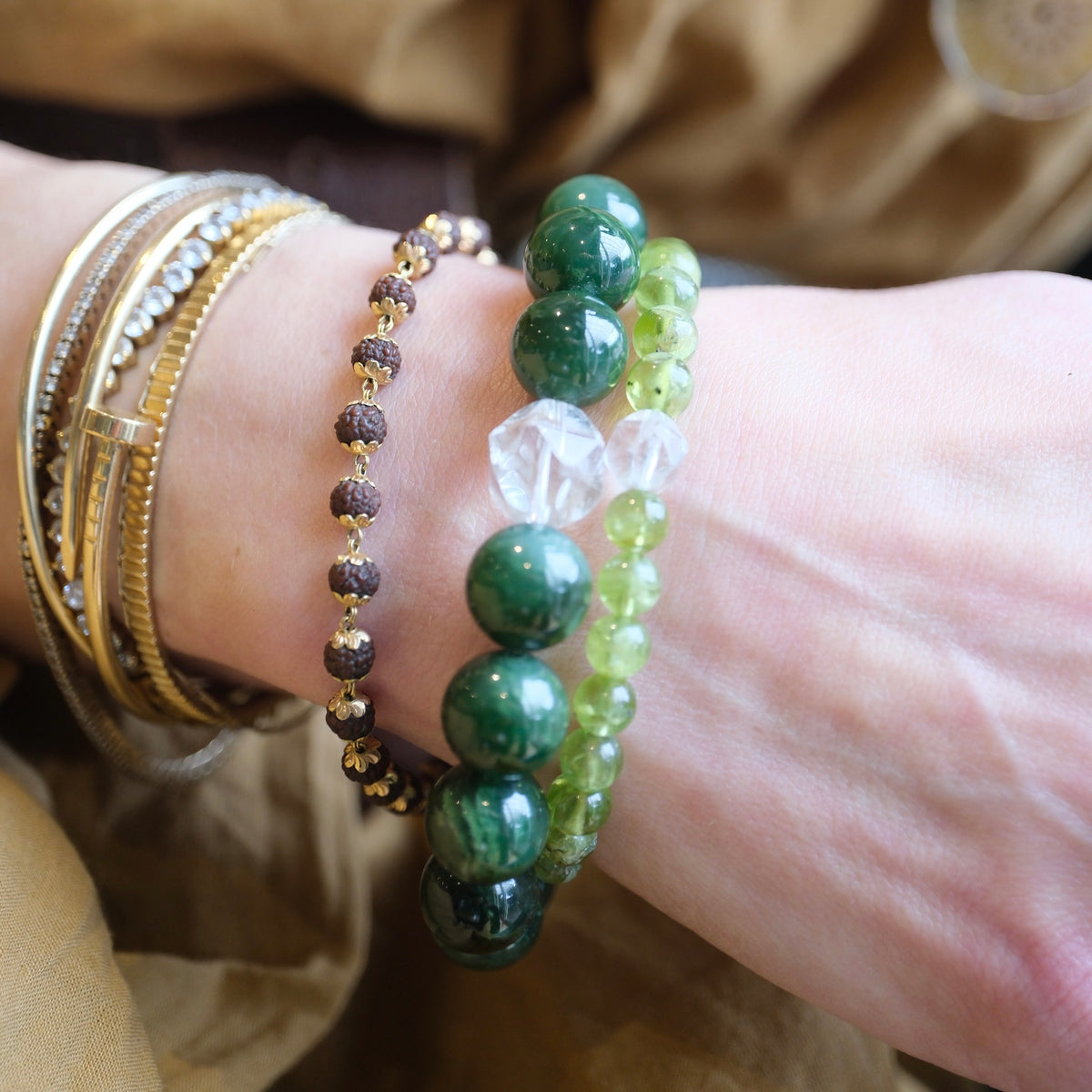 Jade and quartz bracelet stacked at the wrist, serene strength and timeless grace.