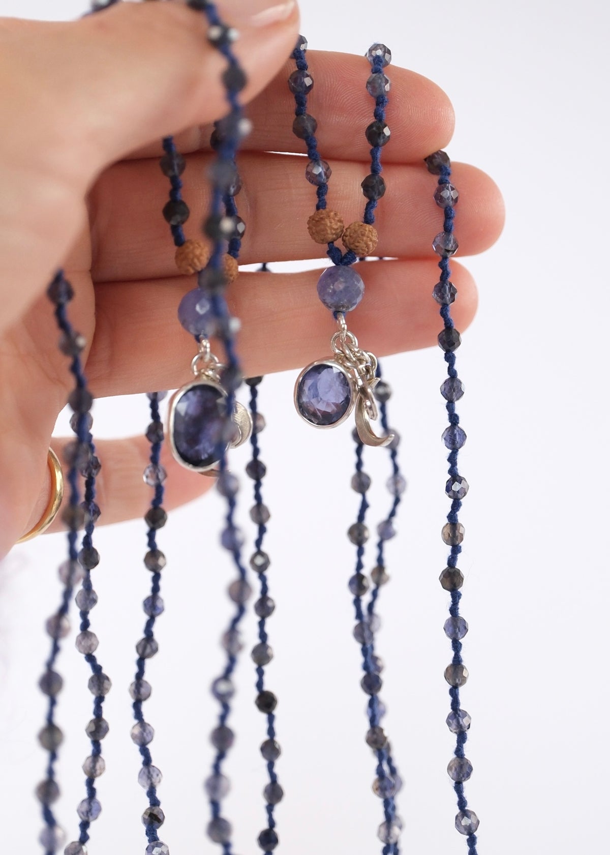 Close view of the faceted iolite pendant and fine iolite beads on the Narayani sou