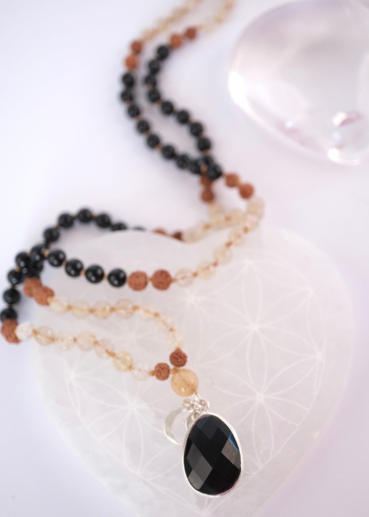 Double sided faceted black tourmaline pendant set in sterling silver with Shivoham charms