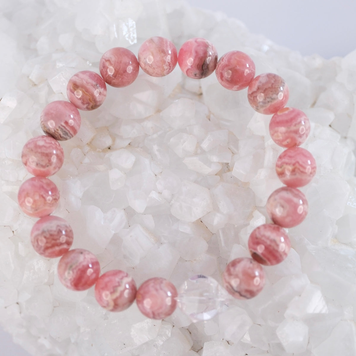 Maha Prana Anand bracelet of superior AAA 10mm rhodochrosite with a Herkimer diamond, for love and bliss.
