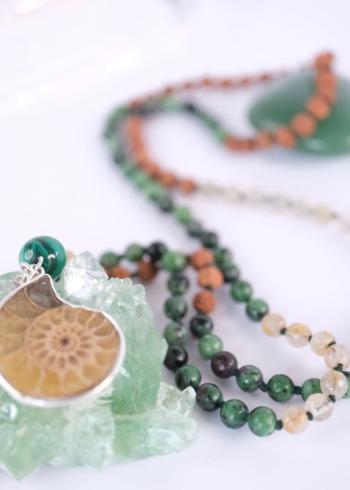 Ammonite Golden Mean spiral pendant on a handcrafted manifestation mala