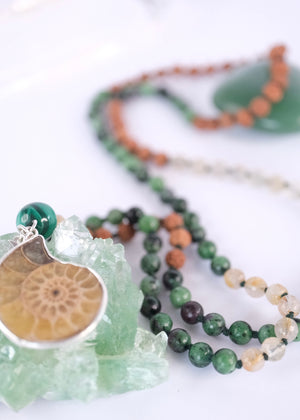 Handcrafted seer’s mala with ammonite pendant, ruby zoisite, golden rutilated quartz, malachite and Rudraksha. Blessed by the Ganga. Magic for sages and manifestation.