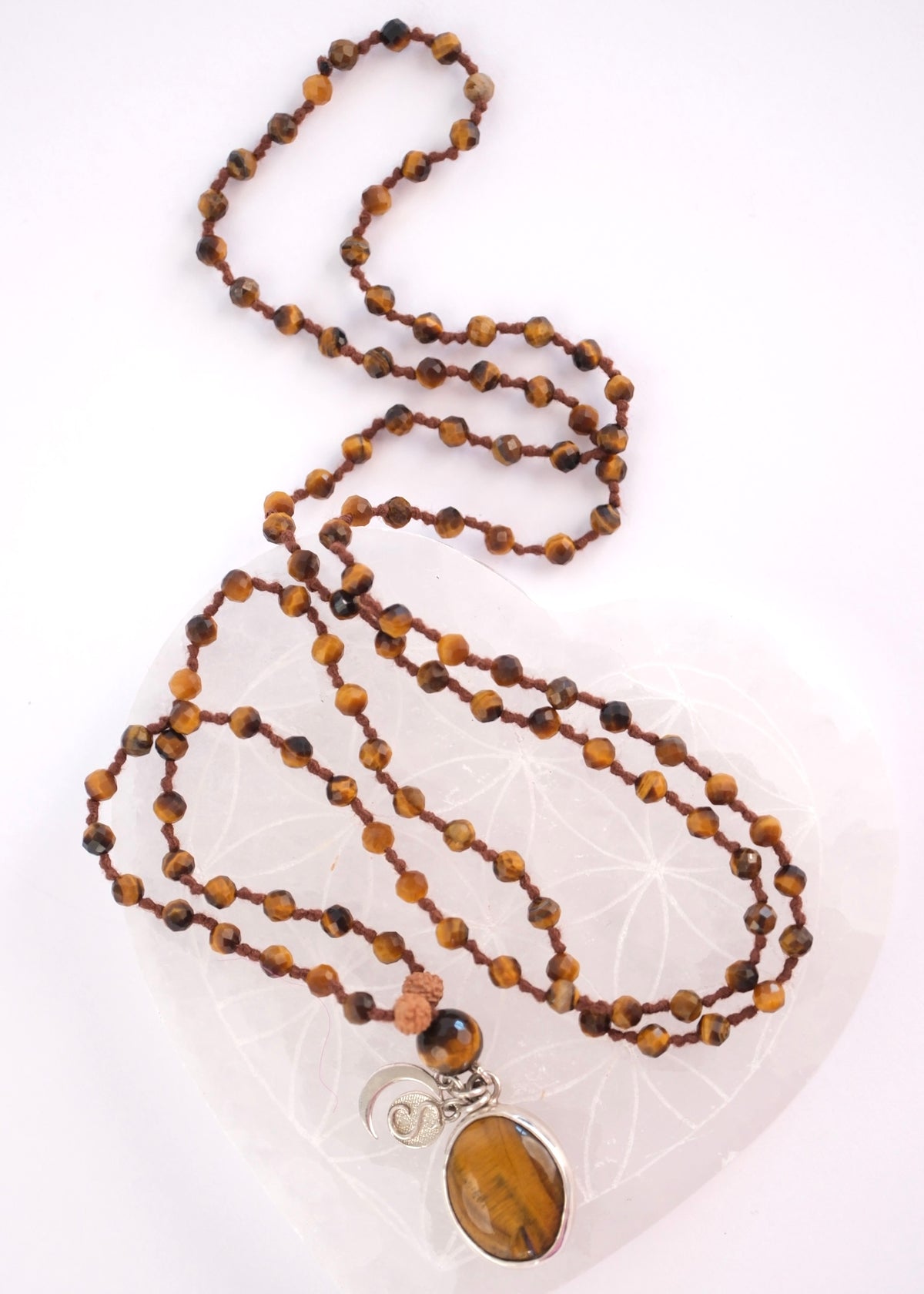 Faceted tiger’s eye beads with Rudraksha above the guru bead on the solar clarity mala with large Tigers Eye Pendant in Silver