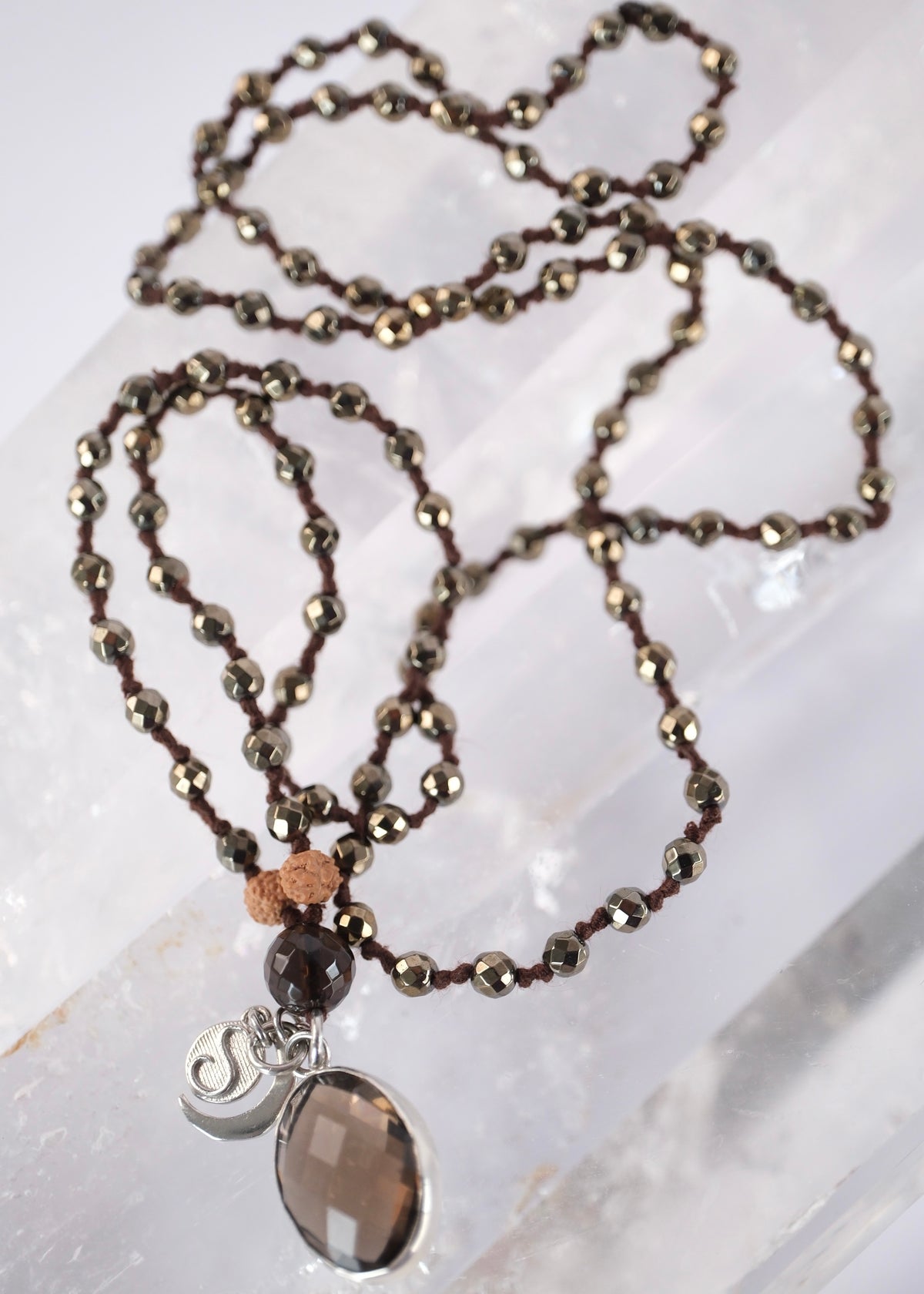 Handcrafted double knotted hematite mala with Rudraksha and a double sided faceted smoky quartz pendant, blessed by Ma Ganga.