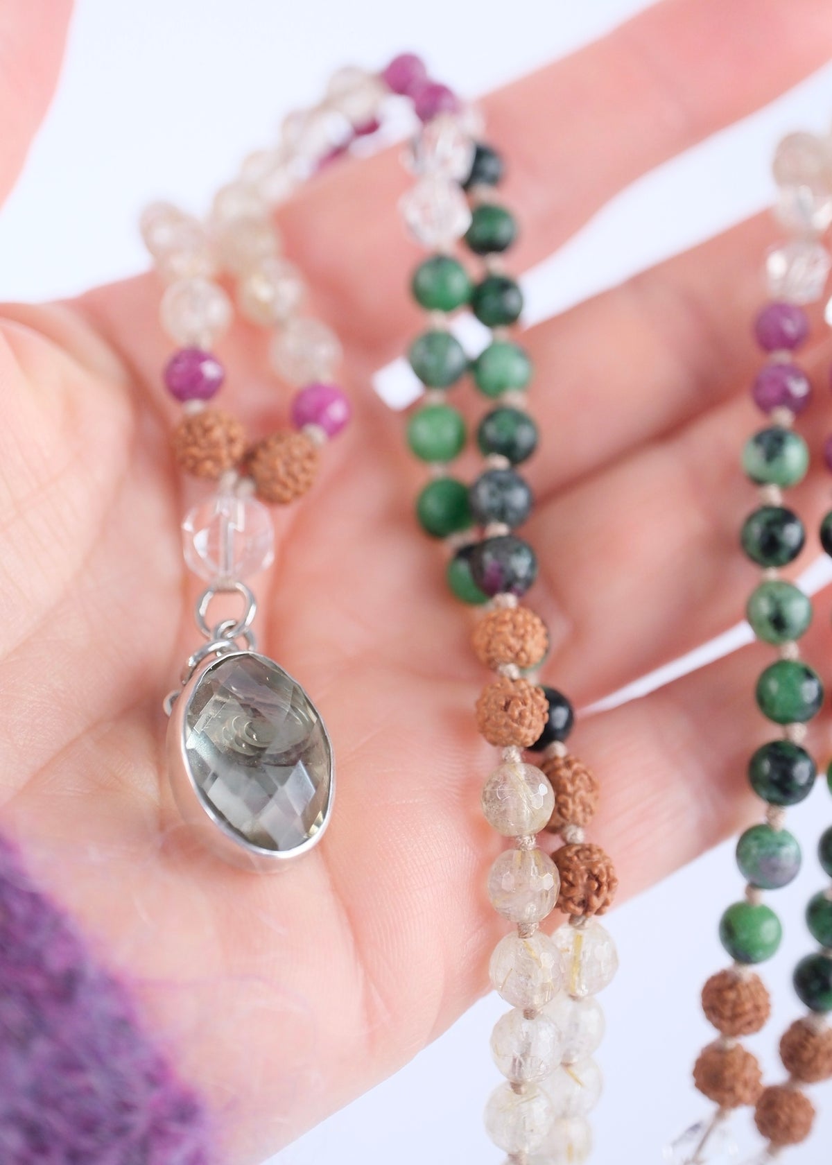 Handcrafted ruby zoisite and golden rutilated quartz mala with Rudraksha and a faceted lemon quartz pendant,