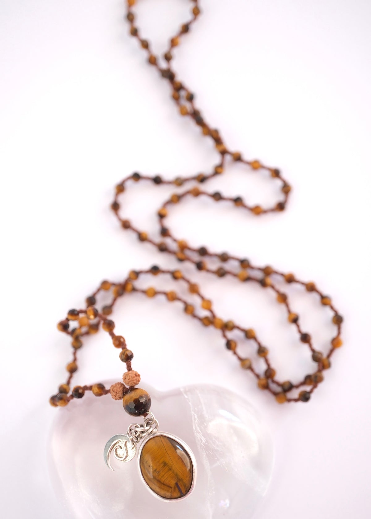 Faceted tiger’s eye beads with Rudraksha above the guru bead on the solar clarity mala