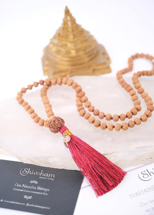Rudraksha mala necklace with authentic red colour tassel and Sri Yantra on a white background