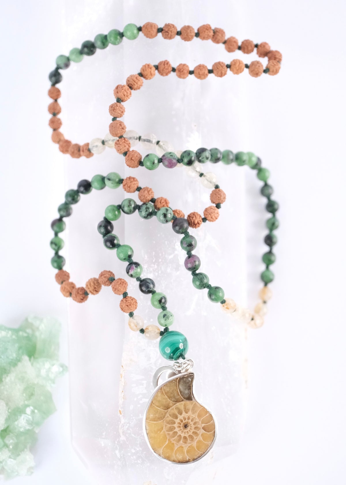 Handcrafted seer’s mala with ammonite pendant, ruby zoisite, golden rutilated quartz, malachite and Rudraksha. Blessed by the Ganga. Magic for sages and manifestation.