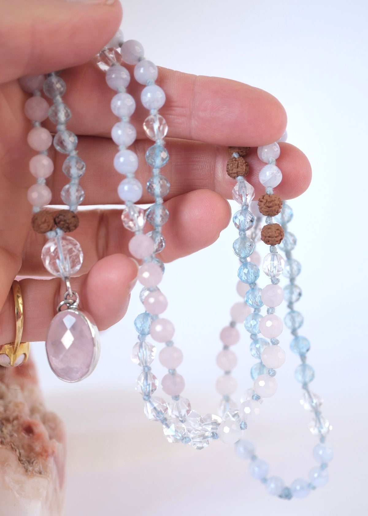 Rose quartz, faceted topaz and Herkimer style quartz beads with Rudraksha on the self love mala