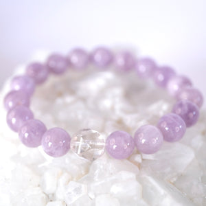 Gentle lilac quartz and Herkimer bracelet soft, serene, and uplifting. ON selenite heart and surrounded by flowers