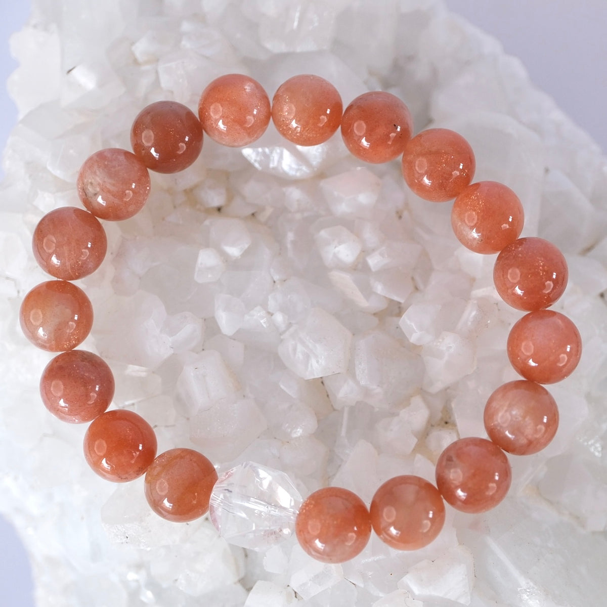 Surya bracelet of rare AAAA 10mm sunstone with a Herkimer diamond, for vitality, abundance, and radiant light.