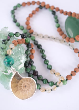 Handcrafted seer’s mala with ammonite pendant, ruby zoisite, golden rutilated quartz, malachite and Rudraksha. Blessed by the Ganga. Magic for sages and manifestation.