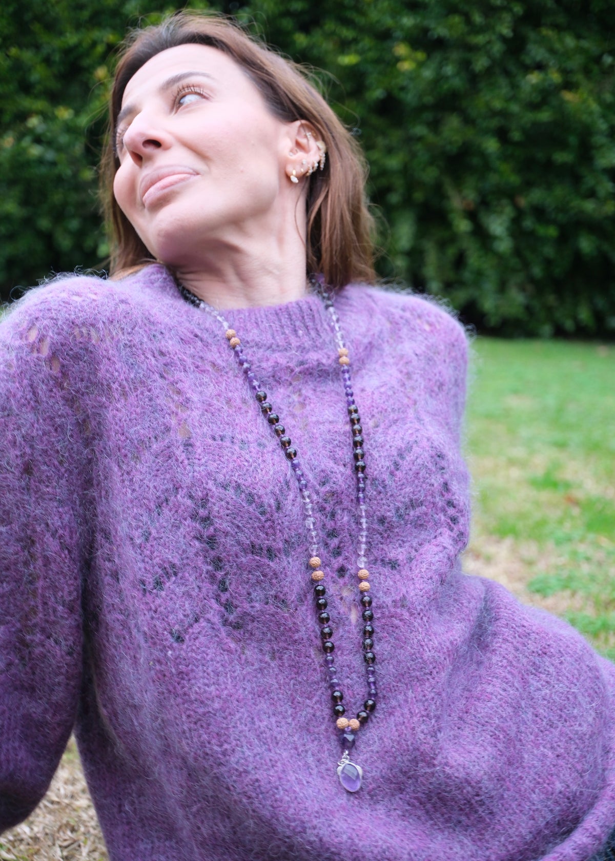 Beautiful Mala beads modelled by woman in purple knit