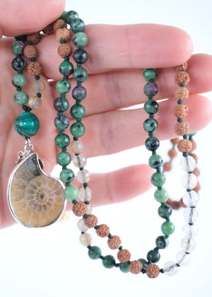 Handcrafted seer’s mala with ammonite pendant, ruby zoisite, golden rutilated quartz, malachite and Rudraksha. Blessed by the Ganga. Magic for sages and manifestation.