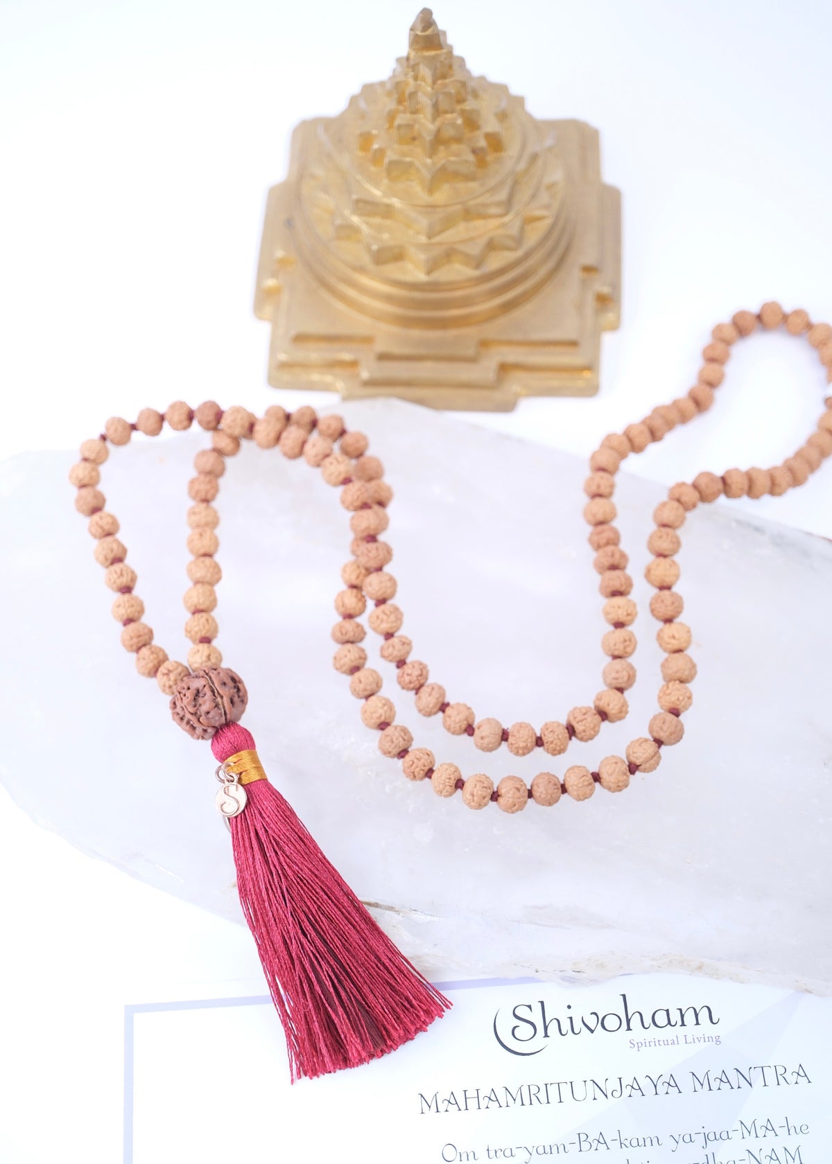 Rudraksha mala necklace with authentic red colour tassel and Sri Yantra on a white background