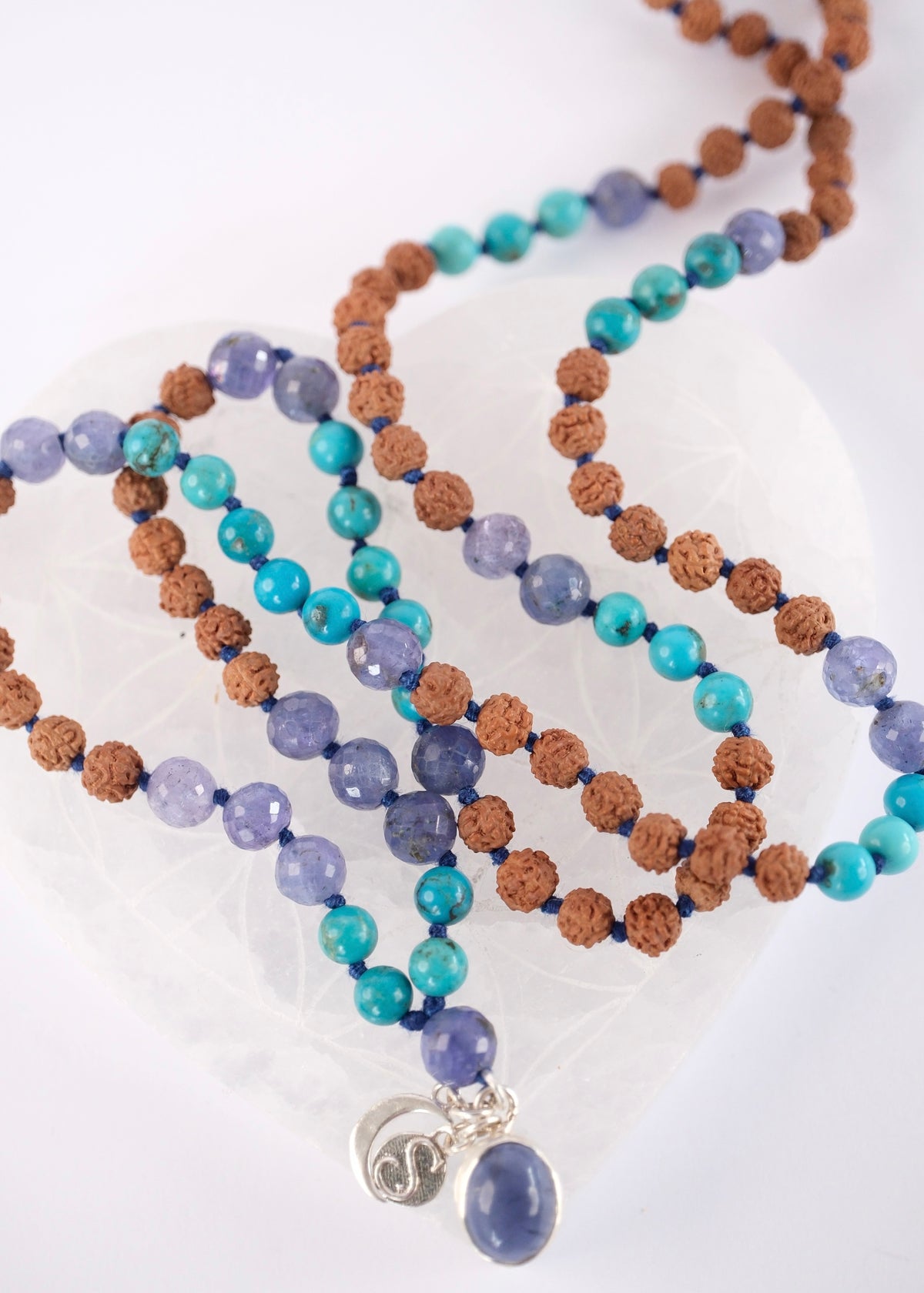 Handcrafted tanzanite and turquoise mala with Rudraksha and an iolite pendant, knotted with mantra and blessed by Ma Ganga.