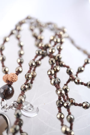 Handcrafted double knotted hematite mala with Rudraksha and a double sided faceted smoky quartz pendant, blessed by Ma Ganga.