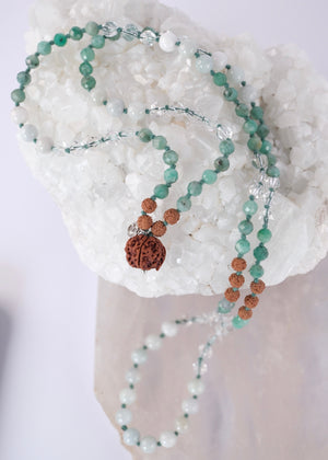 Close up of Emerald Mala with Ganesh Guru bead, herkimer and green jade