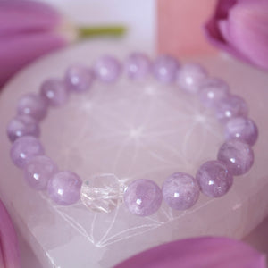 Gentle lilac quartz and Herkimer bracelet soft, serene, and uplifting. ON selenite heart and surrounded by flowers