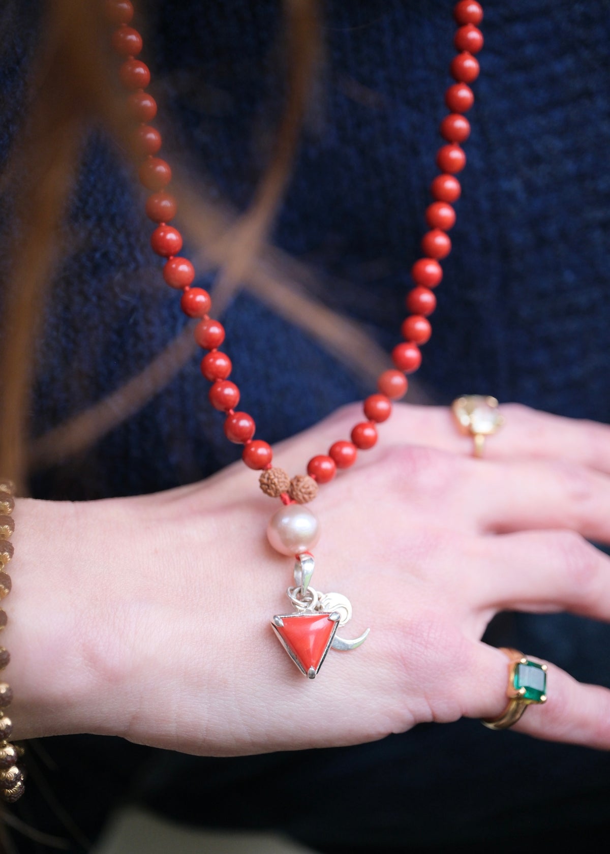 Model wearing the red coral Moonga Mala, Italian coral pendant resting at the heart