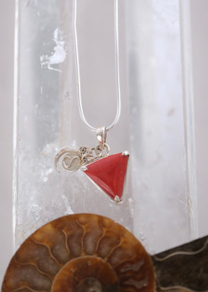 Close view of a deep red Italian coral Mars pendant with crescent moon and S Shivoham charms.