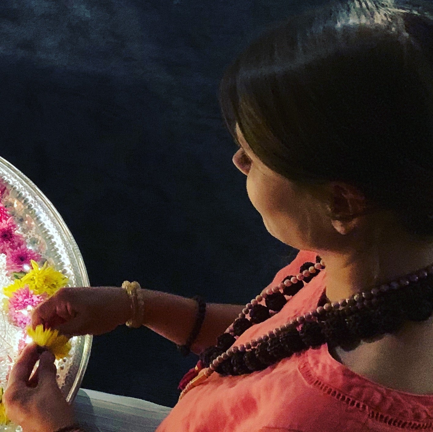 Woman offering flower petals