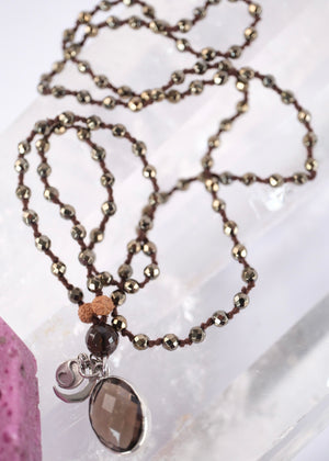 Handcrafted double knotted hematite mala with Rudraksha and a double sided faceted smoky quartz pendant, blessed by Ma Ganga.