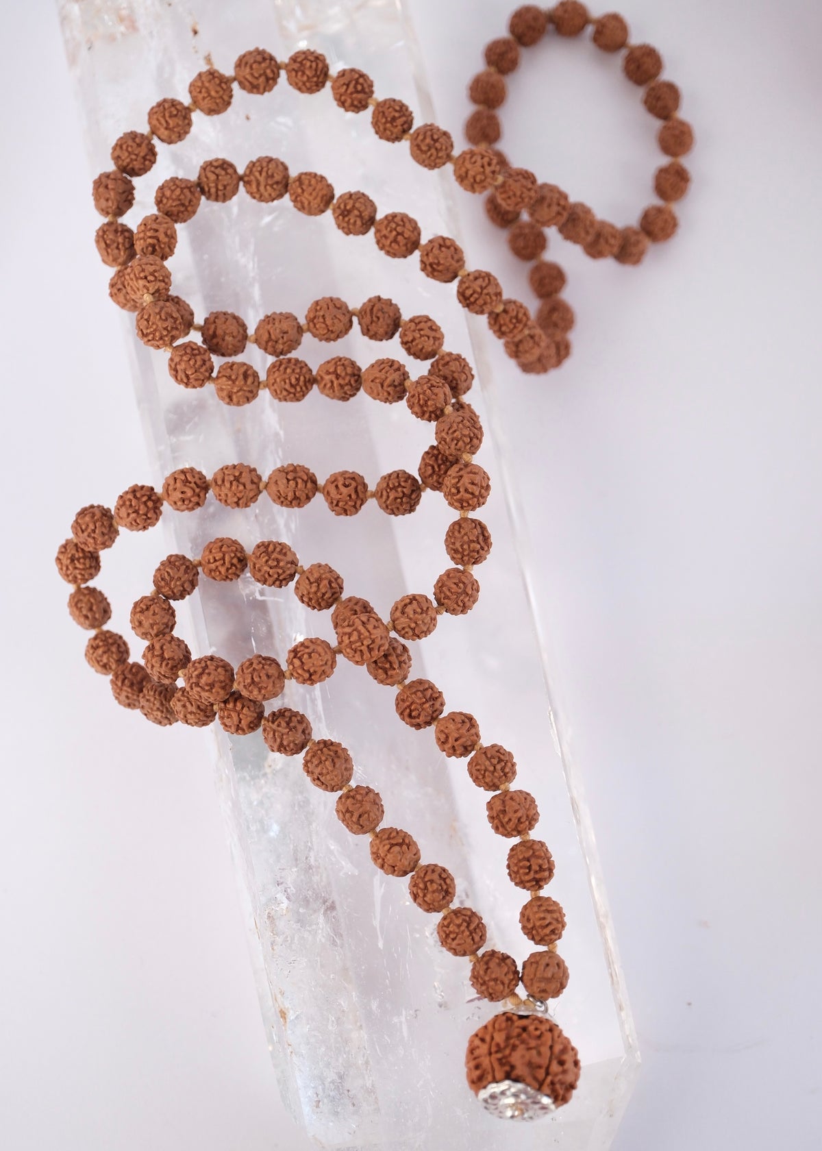 Hand strung Nepal Rudraksha mala with crescent moon and S Shivoham charms, courage joined to wisdom.