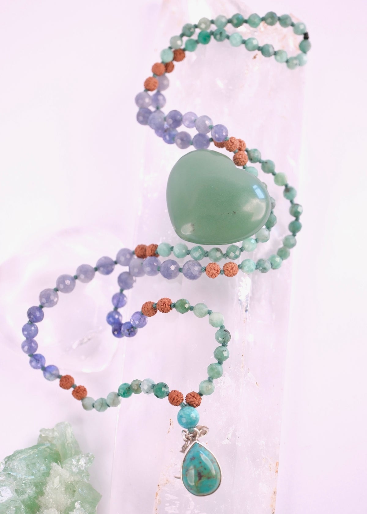 Faceted iolite and emerald beads on a handcrafted Rudraksha success mala with turquoise pendant