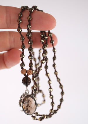 Handcrafted double knotted hematite mala with Rudraksha and a double sided faceted smoky quartz pendant, blessed by Ma Ganga.