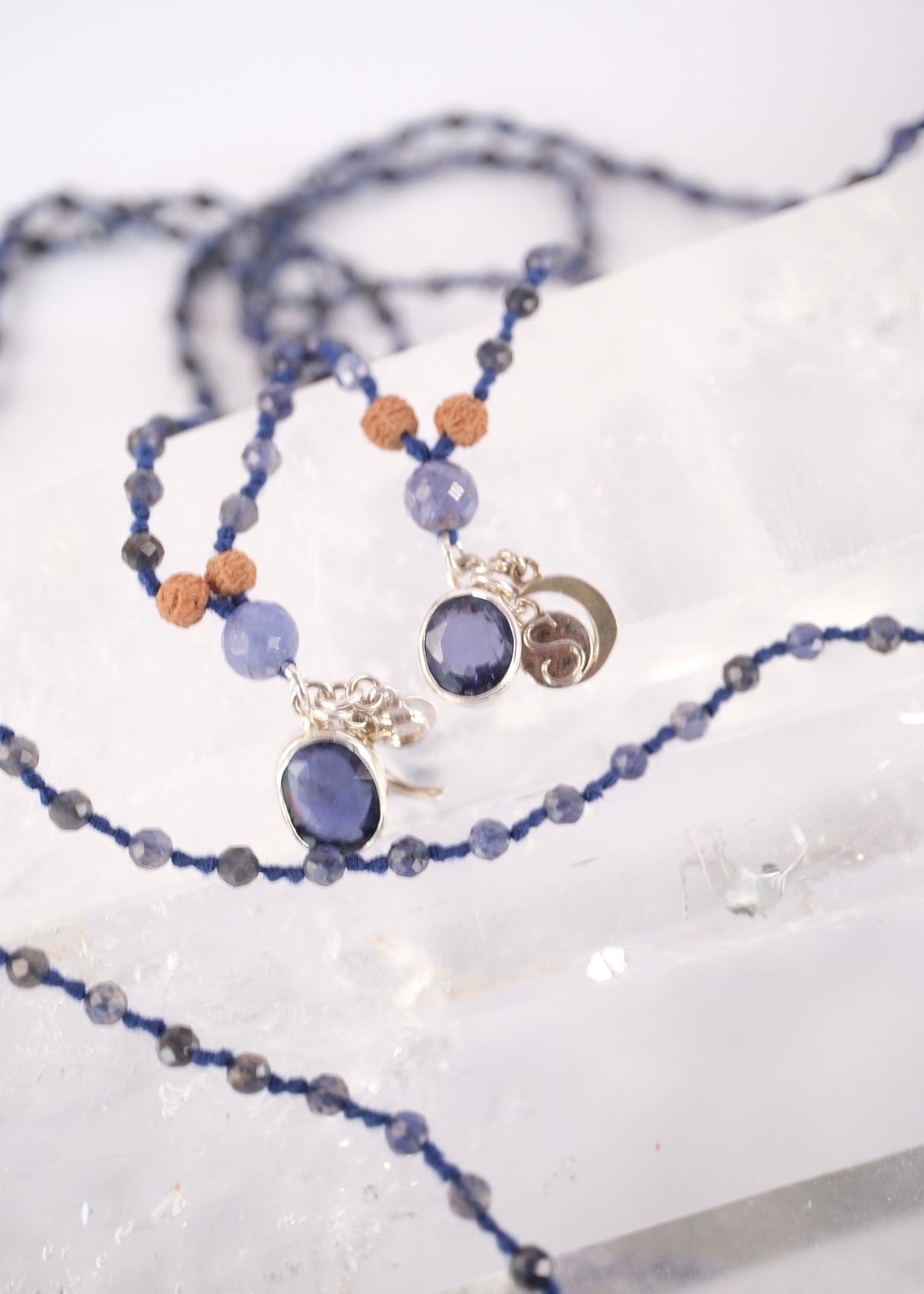 Deep blue faceted iolite prayer mala for intuition, inner vision, and soul connection, finished with a sterling silver iolite pendant close view