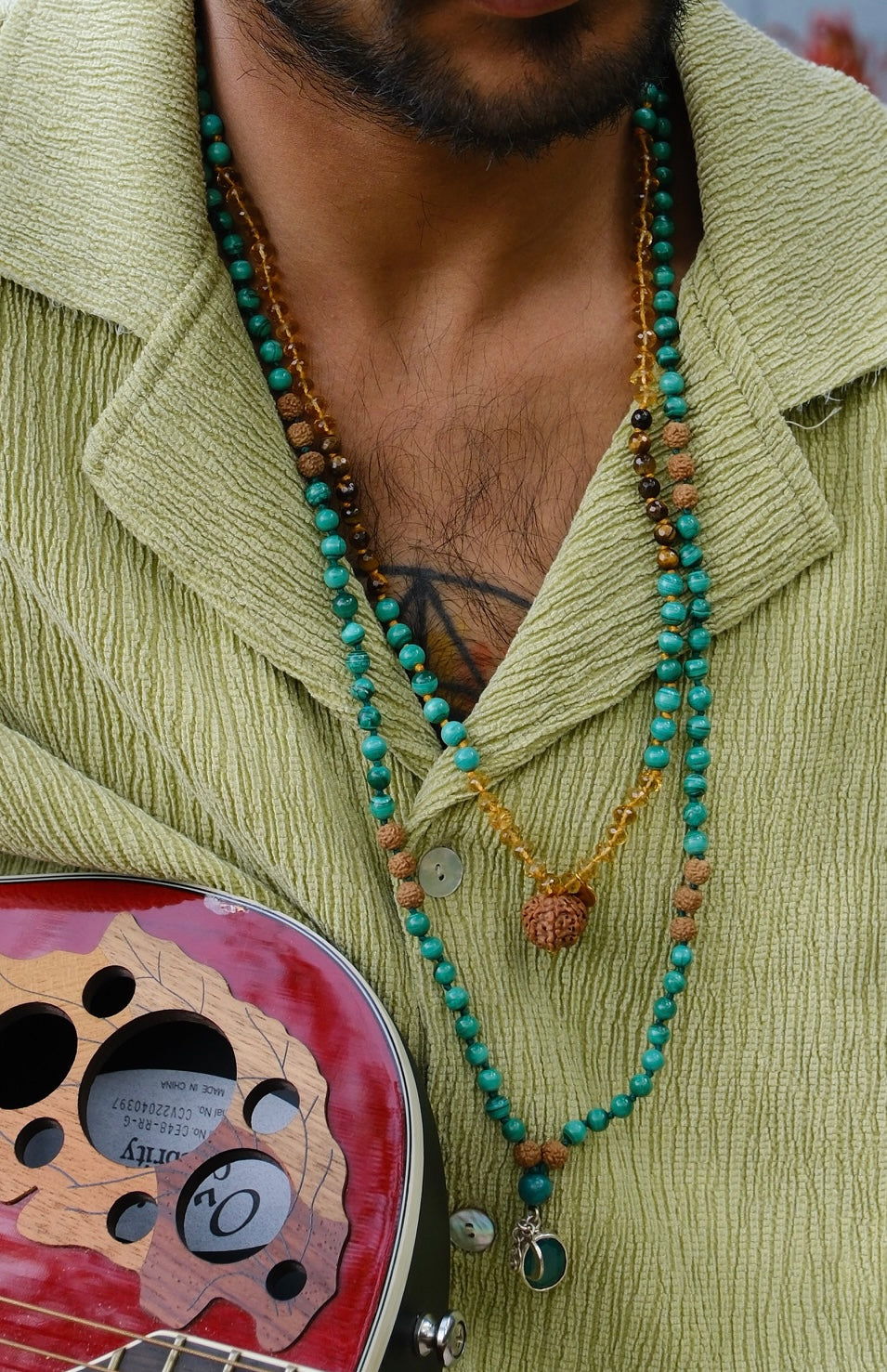 Man wearing Shivoham turquoise and Rudraksha mala beads with sitar, Melbourne Australia