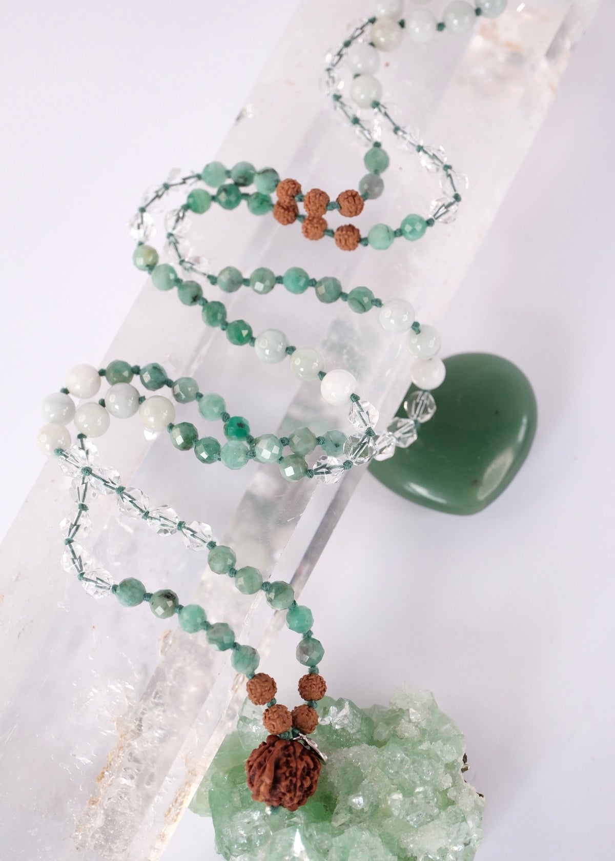 Riddhi mala of vibrant fortune with Burmese jade, faceted emerald, and a rare Nepali Ganesh Rudraksha guru bead in sterling silver.