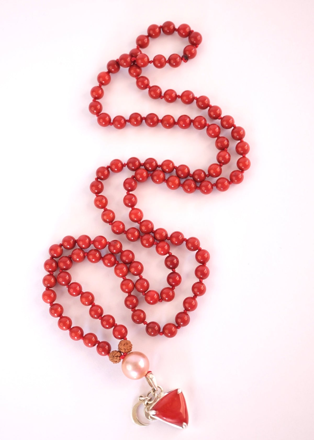 Complete red coral Moonga Mala with Italian coral pendant and Akoya pearl guru bead. Handcrafted red coral Mars mala laid full length with triangular Moonga pendant
