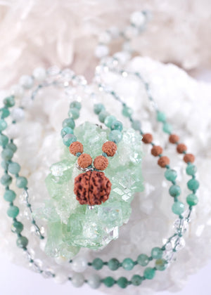 Close up of Emerald Mala with Ganesh Guru bead, herkimer and green jade