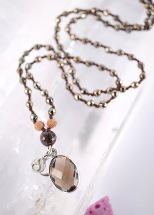 Handcrafted double knotted hematite mala with Rudraksha and a double sided faceted smoky quartz pendant, blessed by Ma Ganga.