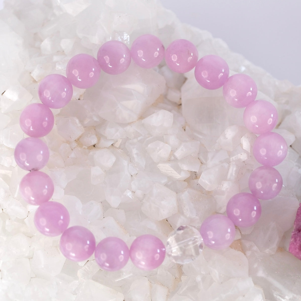 Close view of AAA kunzite beads and a bright Herkimer diamond on the Hridaya Jyoti bracelet.